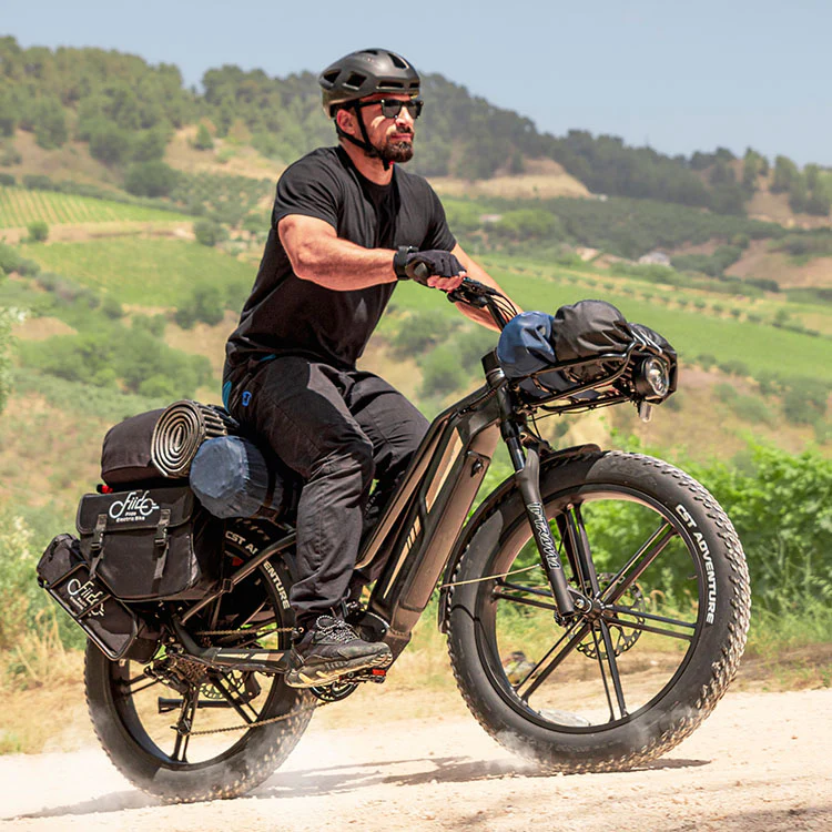 Man on a fat tyre ecargo bike off road terrain 